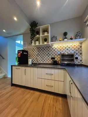 a kitchen with white cabinets and a counter top at Casa do Maestro in Portomarin