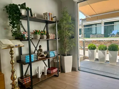 a room with a book shelf with potted plants at Casa do Maestro in Portomarin