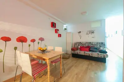 a dining room with a table and a couch at Entrepexigos in Santiago de Compostela