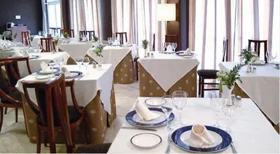 a dining room with tables and chairs with white tables and chairsktop at ARNOIA CALDARIA HOTEL Y BALNEARIO in Arnoia