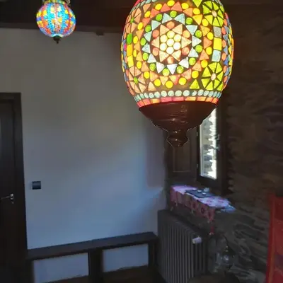 a large stained glass chandelier hanging from a ceiling at El Balcón de Sotillo - Las Médulas - Senderismo por Canales Romanos in Sotillo de Cabrera