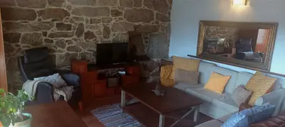 a living room with a couch and a mirror at Apartamento Carballo Do Xurès in Maus de Salas