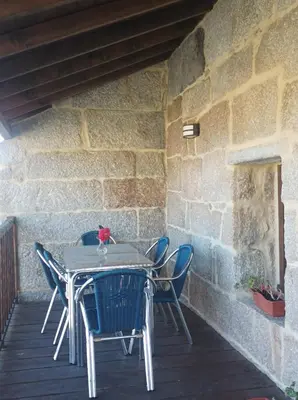 a table and chairs sitting on a patio at Casa do Xurés in Maus de Salas
