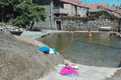 a group of people swimming in a swimming pool at Casa do Xurés in Maus de Salas