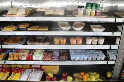 a refrigerator filled with lots of different types of food at Hotel Amenal in Amenal