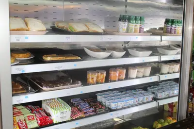 a refrigerator filled with lots of different types of food at Hotel Amenal in Amenal