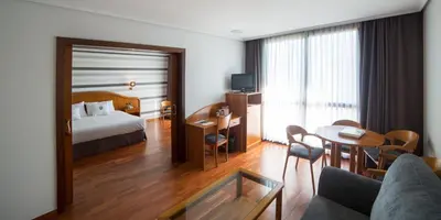 a hotel room with a bed and a table at Laias Caldaria hotel y Balneario in Laias