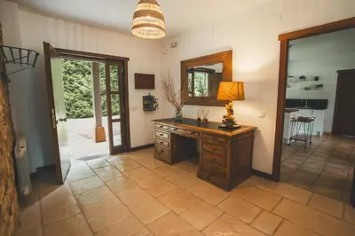 a room with a wooden desk and a mirror at HolaCamp Camino in O Pino