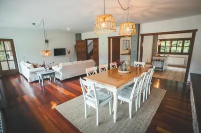 a living room with a wooden table and chairs at HolaCamp Camino in O Pino