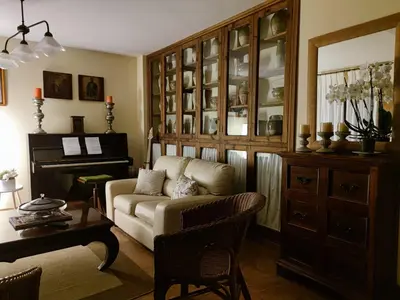 a living room with a couch and a piano at Las Casonas de Avellaneda in Navia