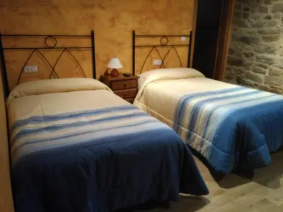 two beds sitting next to each other in a room at Casa dos Eiriz in Souto