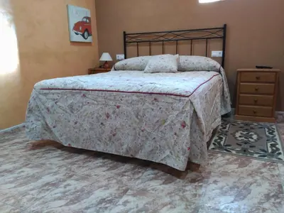 a bedroom with a large bed and a dresser at Casa dos Eiriz in Souto