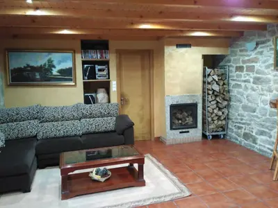 a living room with a couch and a fireplace at Casa dos Eiriz in Souto
