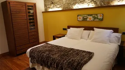 a bedroom with a large white bed with white pillows at Apartamentos Lagos de Saliencia in Saliencia