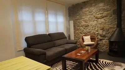 a living room with a couch and a table at Apartamentos Lagos de Saliencia in Saliencia