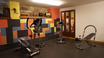 a gym with three exercise bikes in a room at Apartamentos Lagos de Saliencia in Saliencia