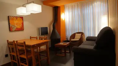 a living room with a couch and a table at Apartamentos Lagos de Saliencia in Saliencia