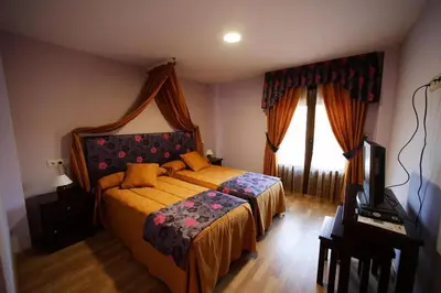 a bedroom with a bed and a window at Posada Real La Yensula in El Puente