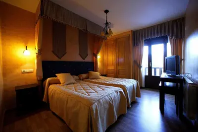 a hotel room with a bed and a television at Posada Real La Yensula in El Puente