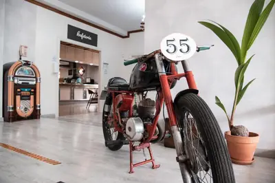 a red motorcycle parked in a room with a kitchen at Hotel Los Olmos in Lugo