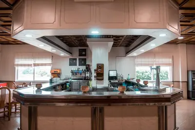 a large kitchen with a large island in a room at Hotel Los Olmos in Lugo