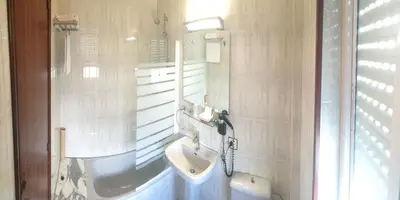 a bathroom with a sink and a toilet in it at Hotel Los Olmos in Lugo