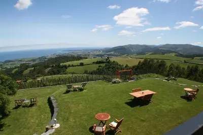 a large field with a picnic table and a playground at Hotel Rural 3 Cabos in El Vallin