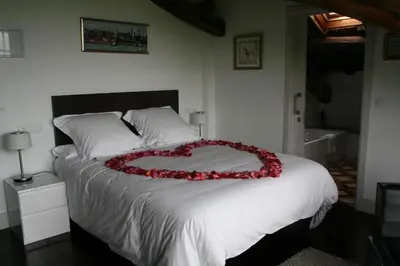 a bed with a heart made out of roses on it at Hotel Rural 3 Cabos in El Vallin