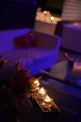 a table with candles and a couch in a room at Motel Paraiso in Outeiro de Rei