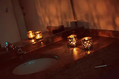 a bathroom with candles on a counter with a sink at Motel Paraiso in Outeiro de Rei