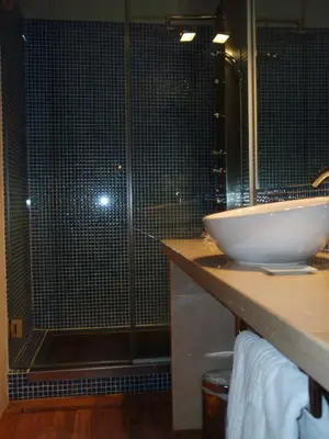 a bathroom with a glass shower and a sink at Posada Real de Las Misas in Puebla de Sanabria