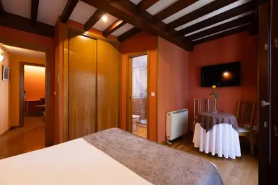 a bedroom with a large white bed in a room at PR Badalada in Santiago de Compostela