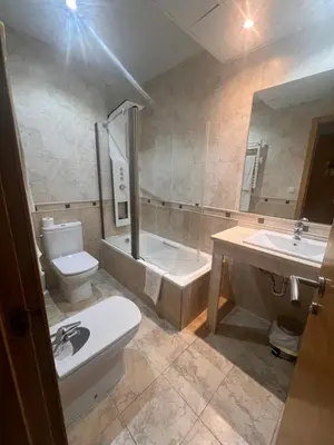 a bathroom with a toilet and a tub and a sink at Hotel Mirador de Barcia in Ribeira de Piquin