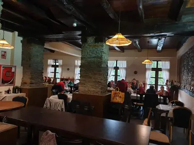 a dining room with people sitting at tables in a restaurant at Hotel Mirador de Barcia in Ribeira de Piquin