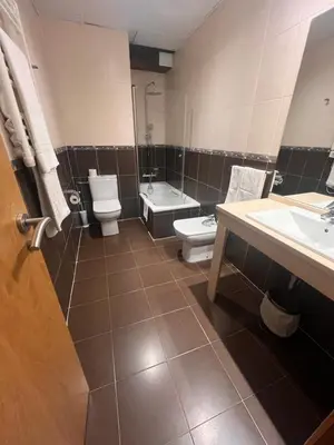 a bathroom with two toilets and a sink at Hotel Mirador de Barcia in Ribeira de Piquin