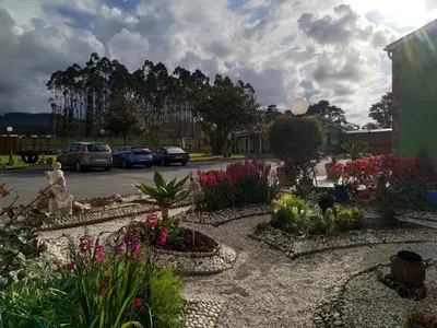 a garden of flowers in a parking lot at El Pinar in Ribadeo
