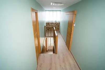 a hallway with a stairway leading to a room at El Pinar in Ribadeo