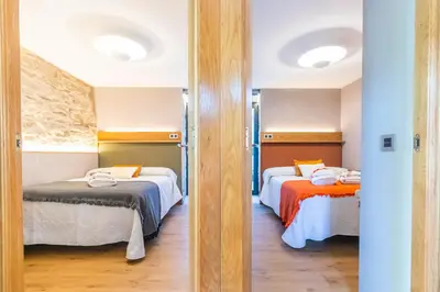 a room with two beds in a room at Casa Costiña in Cotobade