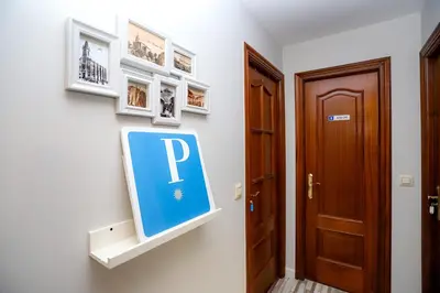 a sign on a wall next to a door at Pensión Caldas in Caldas de Reis