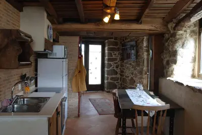 a kitchen with a sink and a table with a counter top at Complejo rural Aira Sacra-Ribeira Sacra in Vilamelle