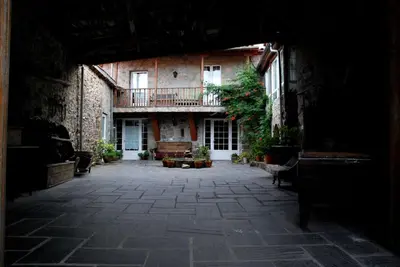 an empty courtyard of a building with a balcony at Casa dos Muros turismo rural y actividades en la Ribeira Sacra in Pantón