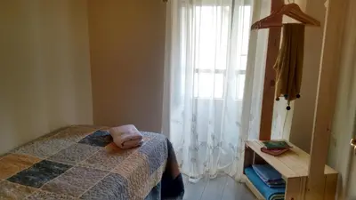 a bedroom with a bed and a window at Casa fonte da pena in Rinlo