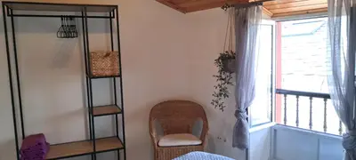 a room with shelves and a chair and a window at Casa fonte da pena in Rinlo