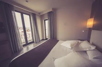 a bedroom with a large bed and a large window at Hotel Aroi Ponferrada in Ponferrada