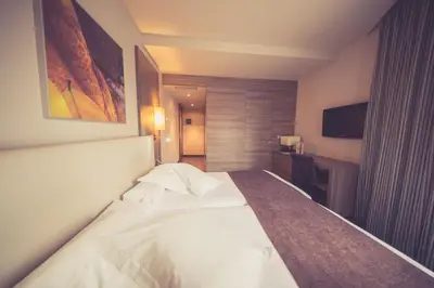 a hotel room with a bed and a television at Hotel Aroi Ponferrada in Ponferrada