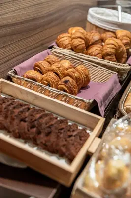 a bunch of different types of donuts and other pastries at Hotel Aroi Ponferrada in Ponferrada