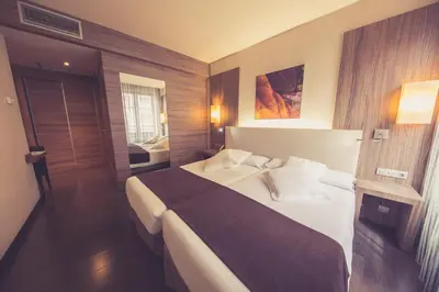 a bedroom with a large bed in a room at Hotel Aroi Ponferrada in Ponferrada