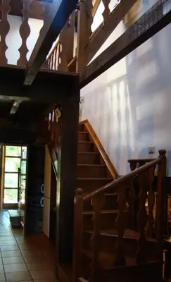 a wooden staircase in a house with a stair case at Casa dos Pedrouzos in Doncos