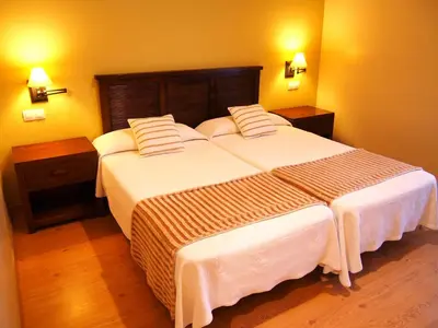 a bedroom with two beds and two night stands at Hotel Balcón de San Bartolo in Barreiros