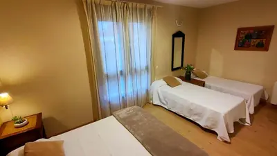 a hotel room with two beds and a mirror at Hotel Balcón de San Bartolo in Barreiros
